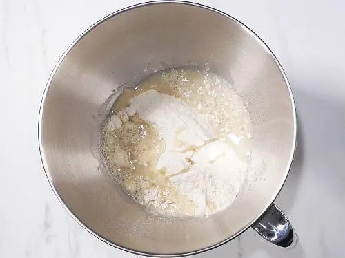 mixing flour, salt and oil for aloo paratha dough