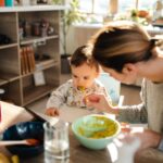 Mother feeding baby purees for the first time