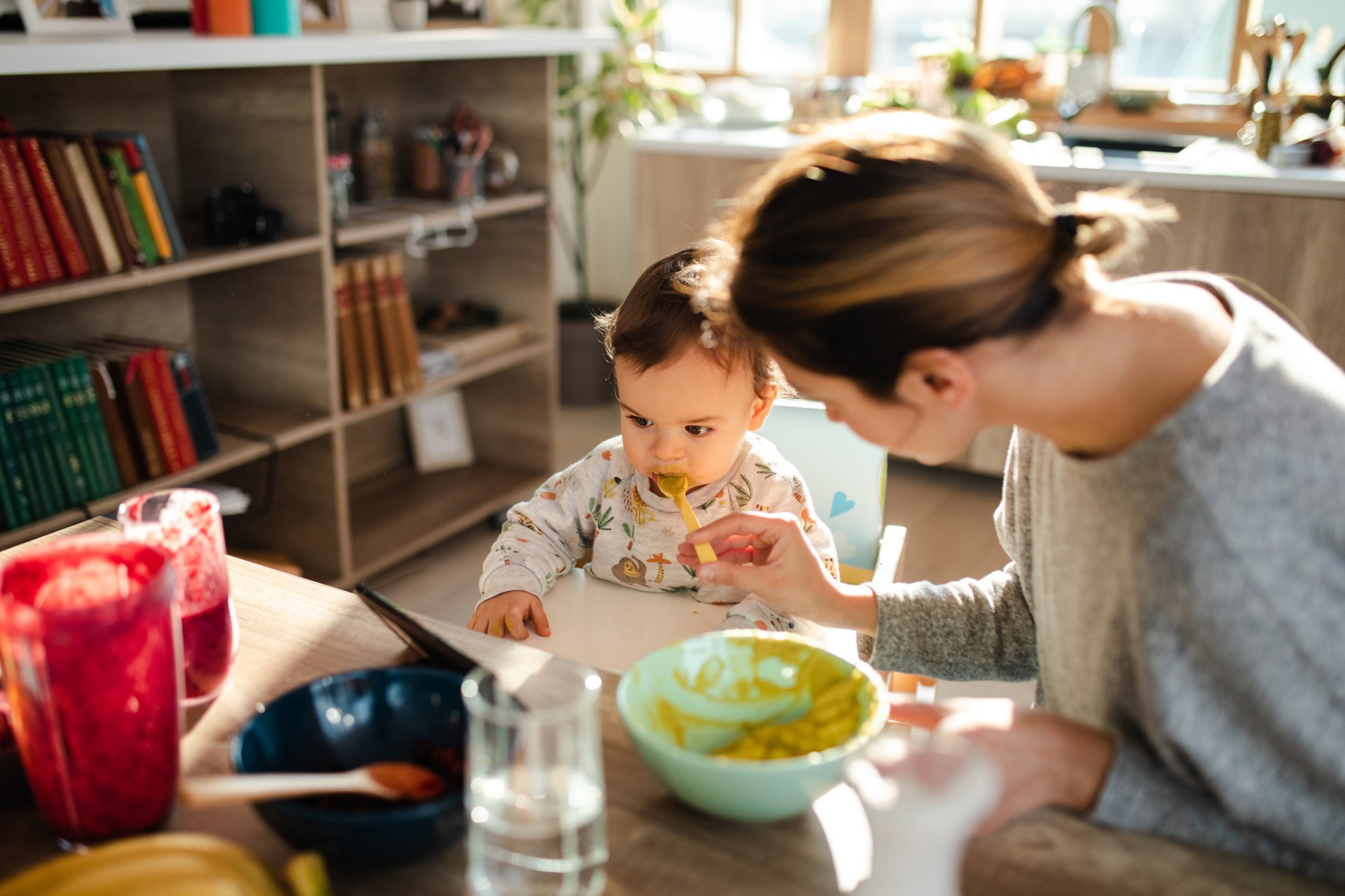 Mother feeding baby purees for the first time