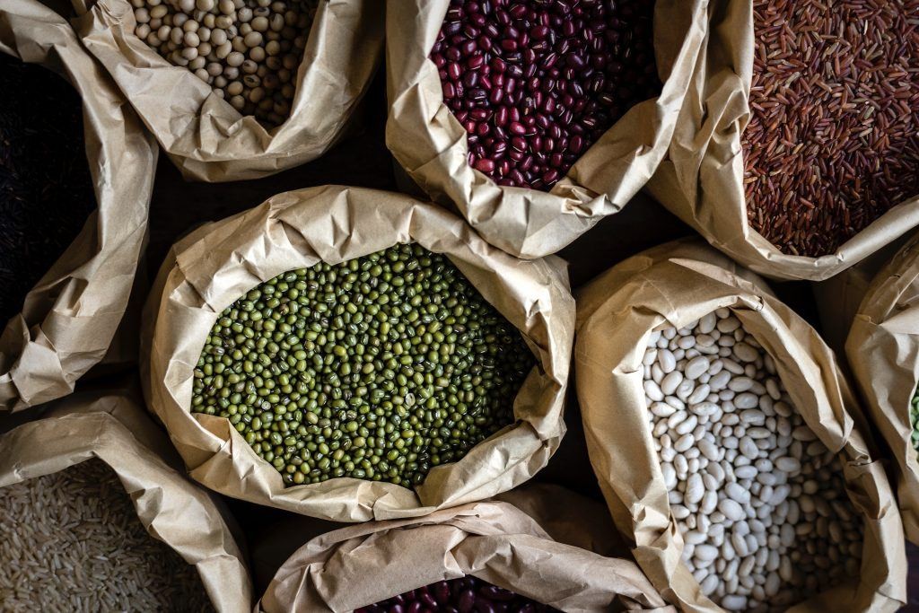 Paper bags filled with dry beans, peas, lentils, and rice