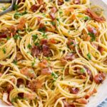 Pasta carbonara shown in a large white serving bowl.