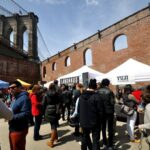 People enjoying the atmosphere and food at Smorgasburg food market new york