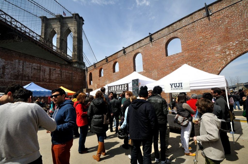 People enjoying the atmosphere and food at Smorgasburg food market new york