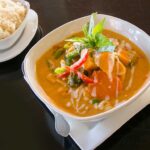 pumpkin curry with kabocha pumpkin, broccoli, carrot, cauliflower, and green beans, a vibrant and healthy thai red curry delivery option