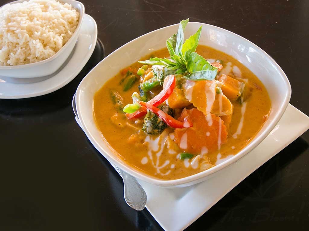 pumpkin curry with kabocha pumpkin, broccoli, carrot, cauliflower, and green beans, a vibrant and healthy thai red curry delivery option