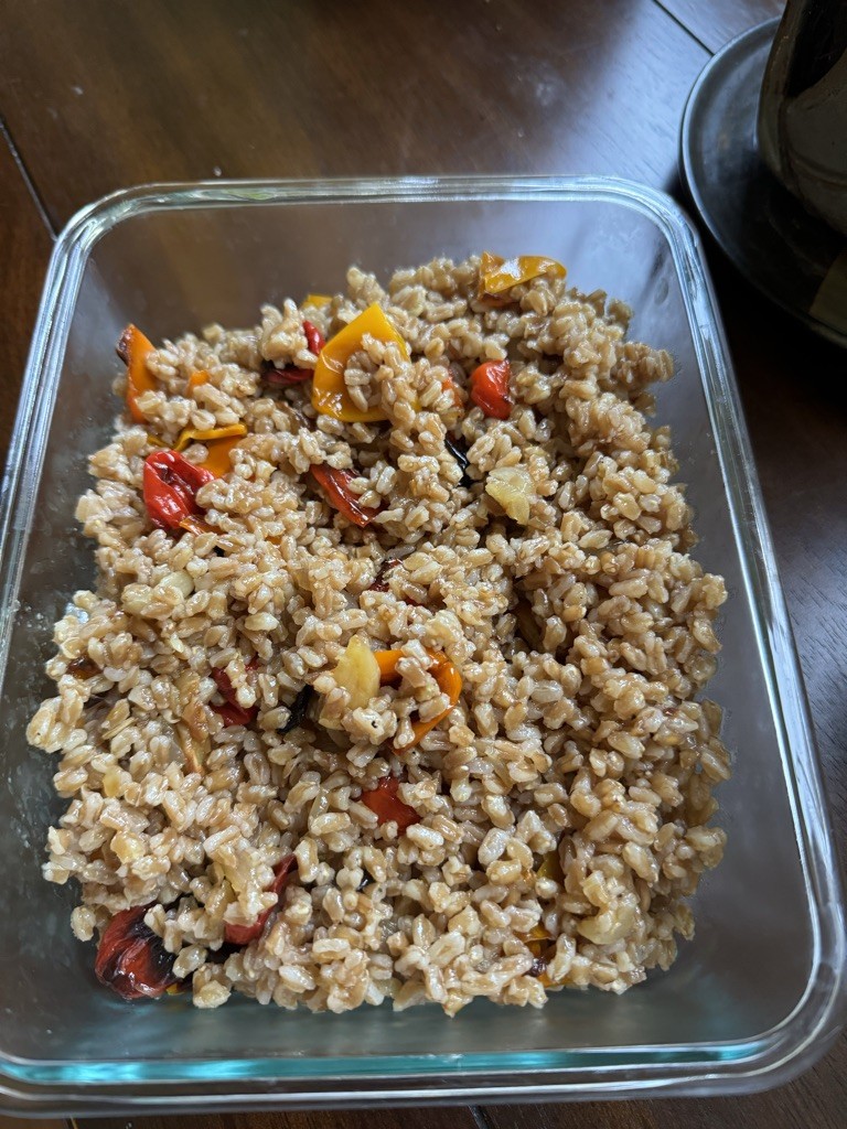 Roasted sweet peppers, onions, and garlic cloves on a baking sheet, showcasing vibrant colors and slight charring, ideal for fall recipes.