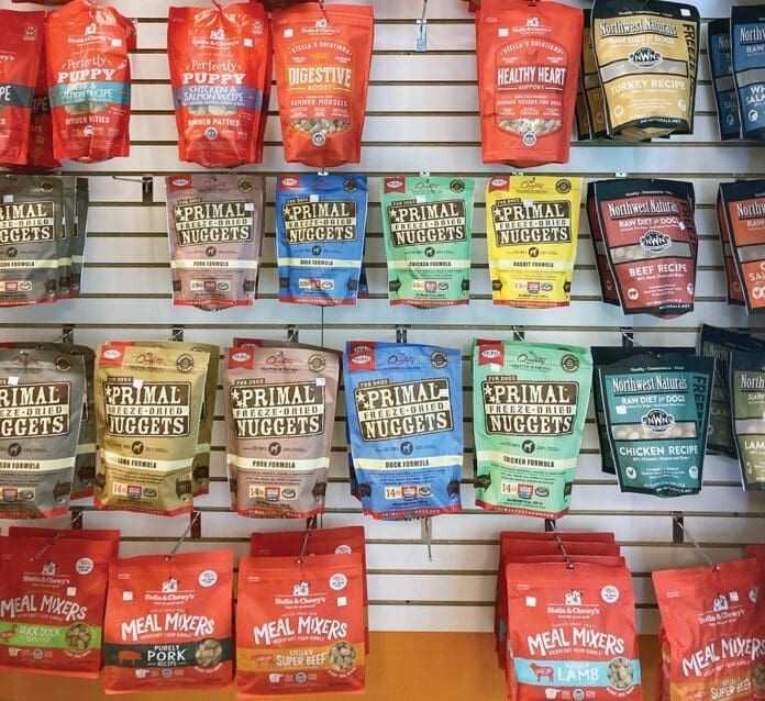 Selection of dehydrated and freeze-dried dog food options in a pet store, highlighting variety and natural ingredients.