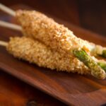 Sesame Pancetta Asparagus Sticks elegantly arranged for a party