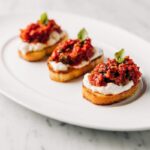 Stracciatella Bruschetta: Fresh Italian appetizer with tomatoes and cheese