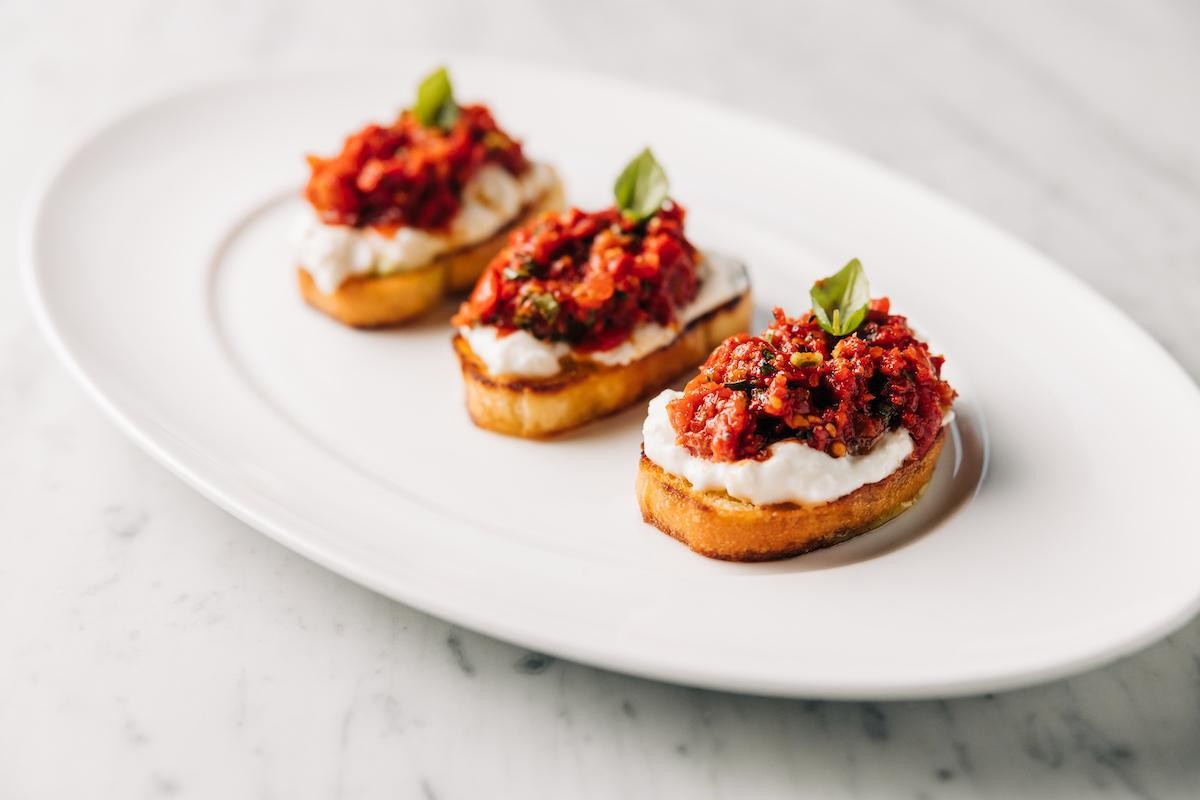 Stracciatella Bruschetta: Fresh Italian appetizer with tomatoes and cheese