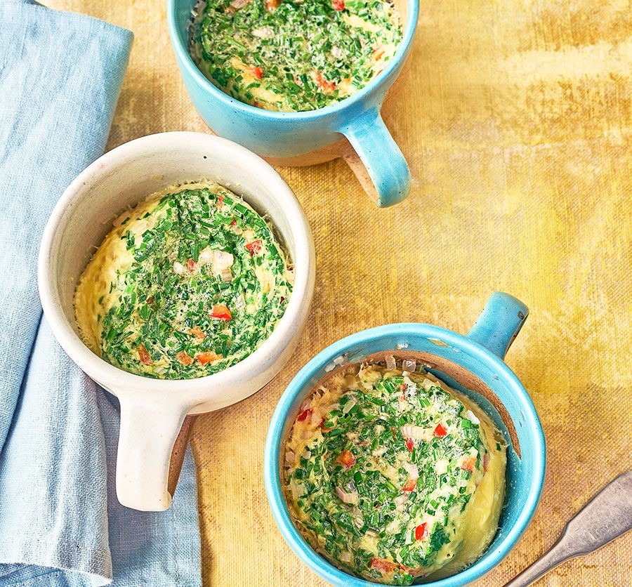 Three microwave mug omelettes in mugs with various fillings