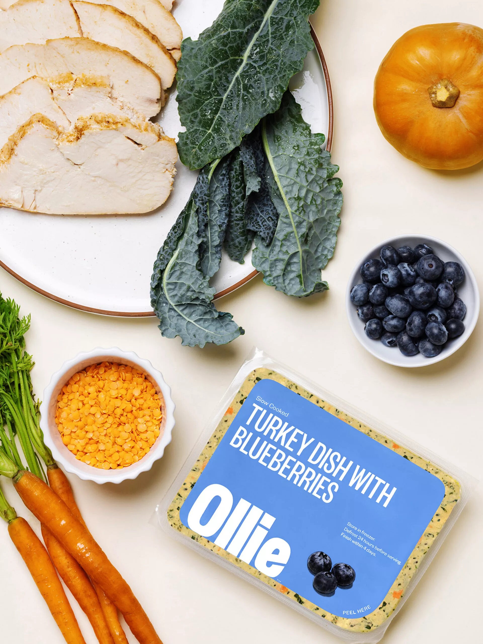 Two fresh Ollie dog food meal plans are displayed, showcasing the variety of ingredients and convenient packaging.