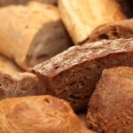 Variety of German breads including rye bread, mixed grain bread, and white bread rolls