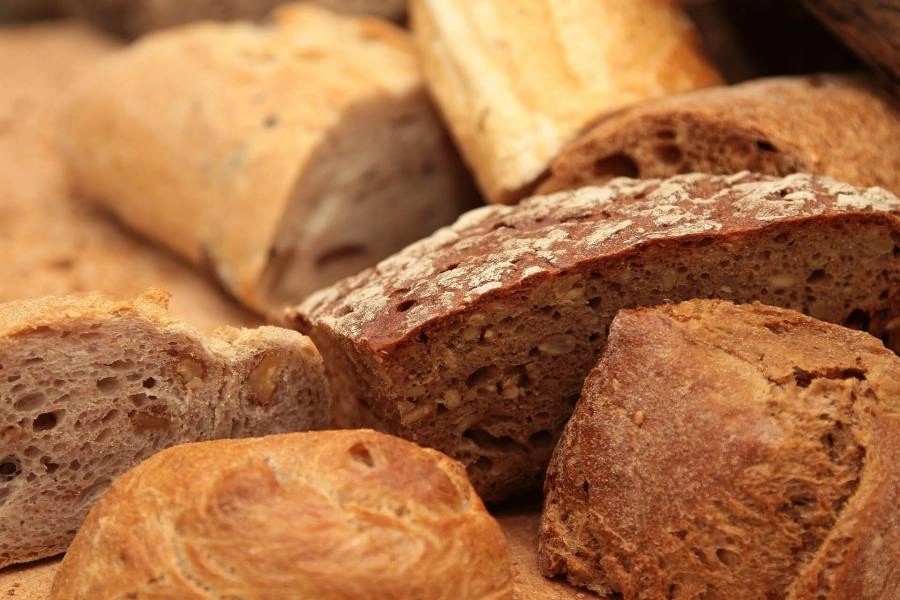 Variety of German breads including rye bread, mixed grain bread, and white bread rolls