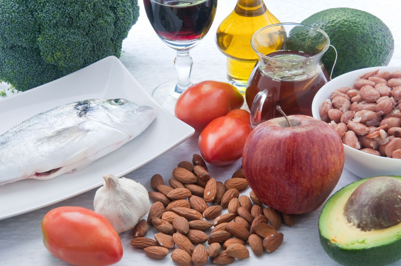 Variety of high cholesterol lowering foods including oats, nuts, fruits, and vegetables for a heart-healthy diet