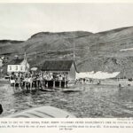 Vintage photograph of a 19th-century fishing pier in Eskifjörður, Iceland, showcasing the historical importance of fishing in Iceland's food culture