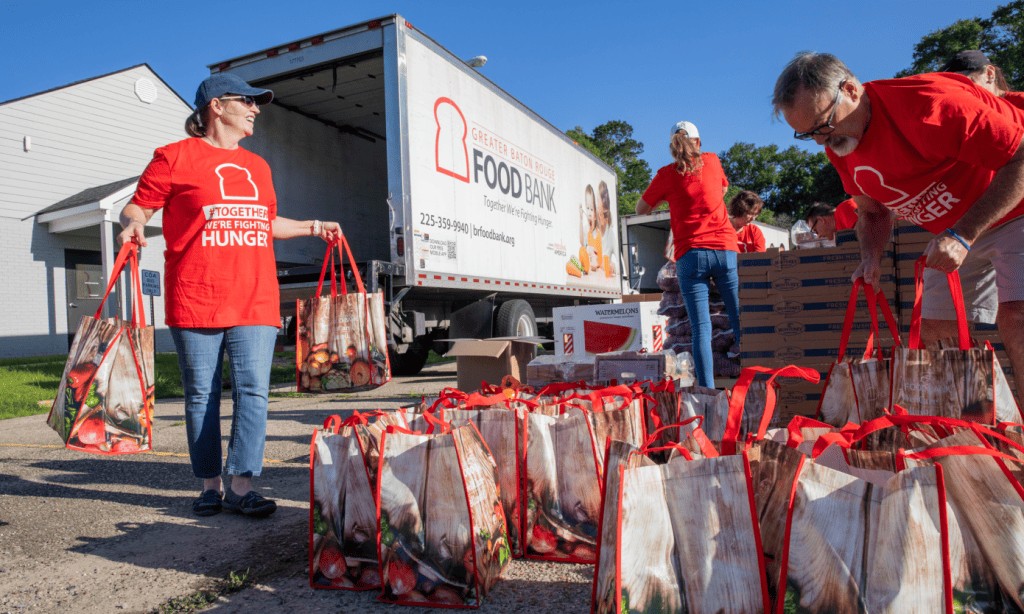 Volunteers and employees of the Baton Rouge Food Bank working together to collect and distribute food.