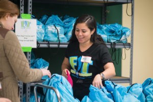 Volunteers preparing healthy fit food bags to support food-insecure children in Central Texas.