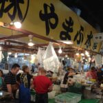 Wholesale activity at Tsukiji Fish Market showcasing the bustling trade of fresh seafood.