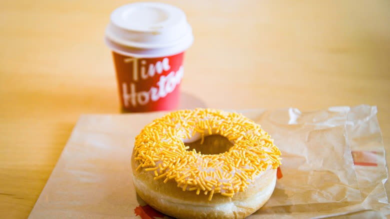 A Tim Hortons coffee and donut, a classic pairing that can be enjoyed at any hour