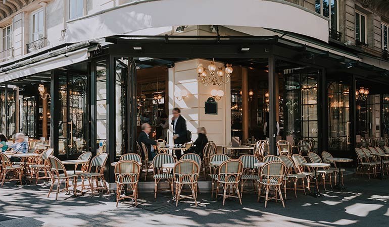 A welcoming bistro entrance with outdoor seating