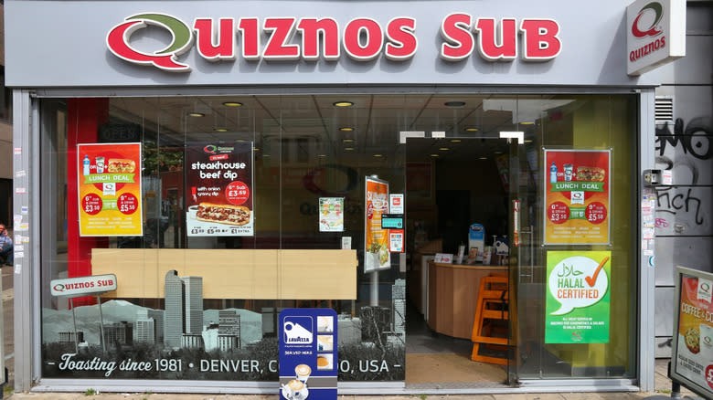 The outside of a Quiznos, signaling its return to the sandwich scene with all-day breakfast options