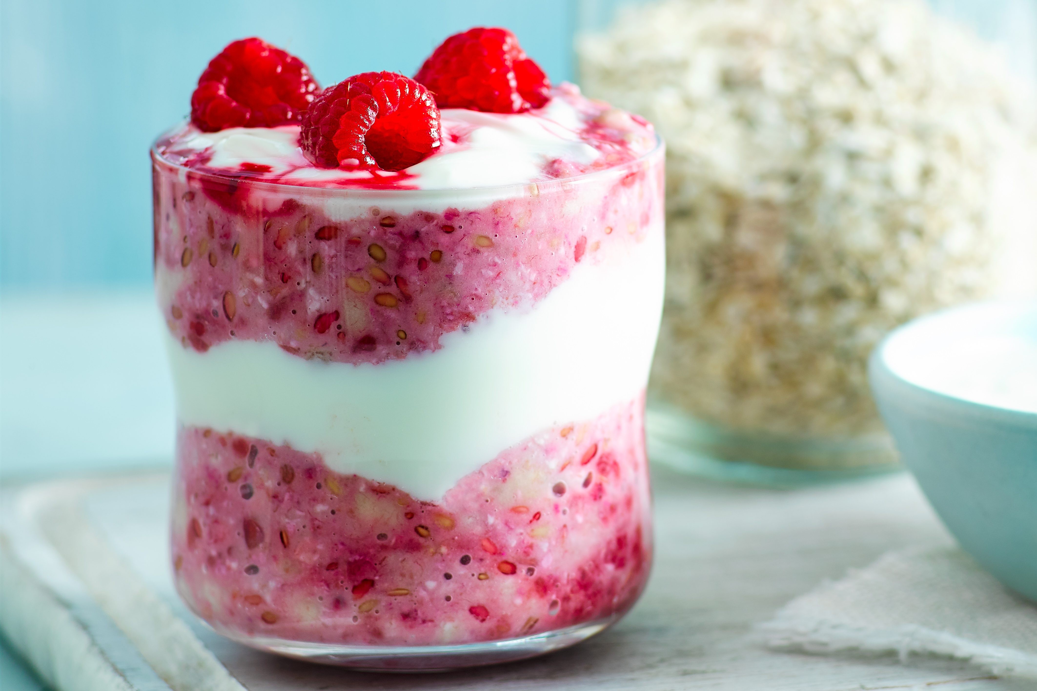 Glass pot of berry bircher muesli, featuring layers of yogurt, oats, and fresh berries, perfect for a nutritious breakfast or snack.
