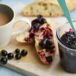 Blackcurrant jam with bread and a cup of tea
