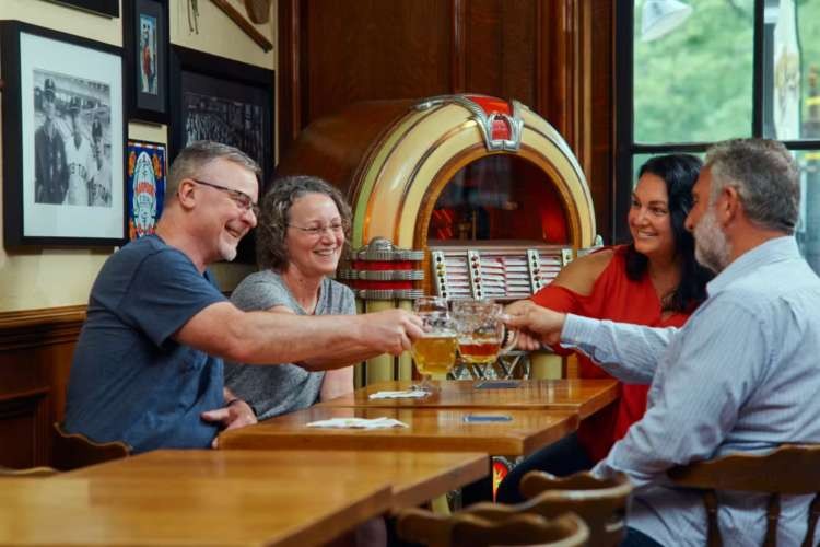 Friends cheers beer at Cheers restaurant