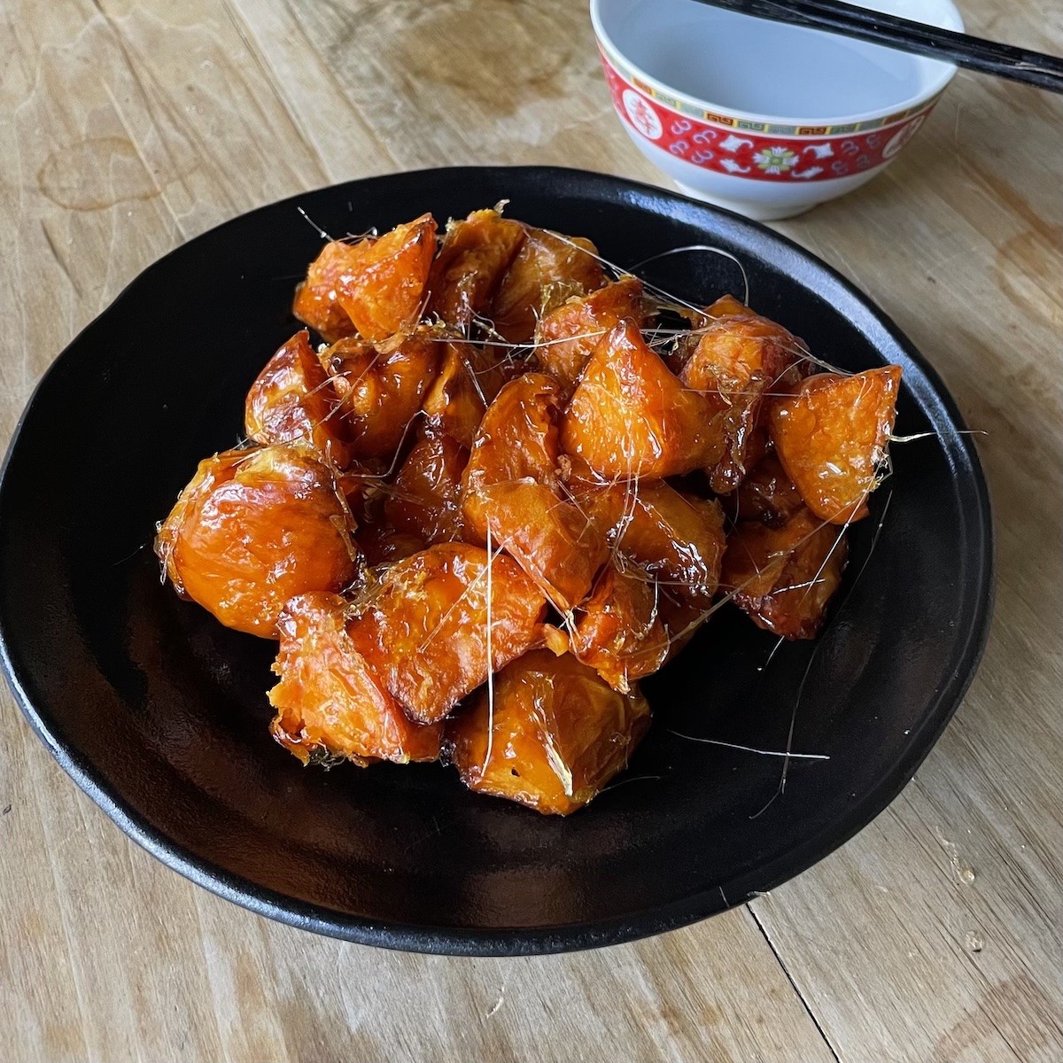 Chinese Candied Sweet Potatoes served with a bowl of cool water