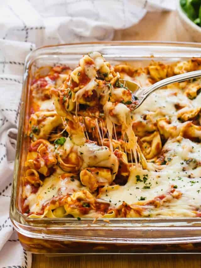 Baked cheese tortellini in glass dish.