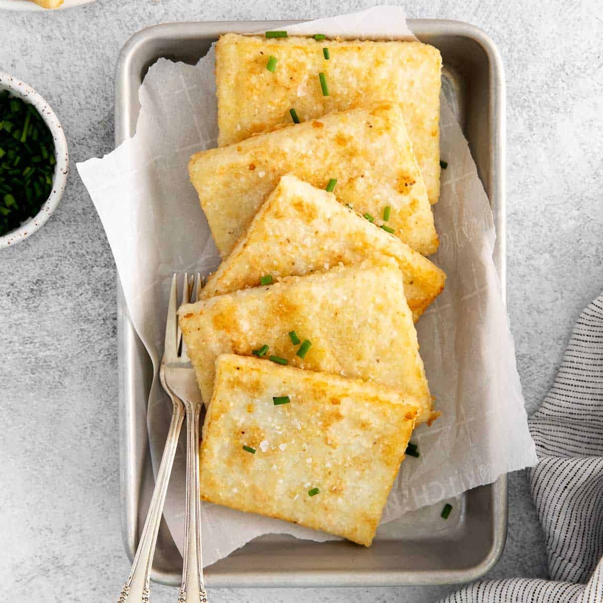 Grits cakes on a serving tray