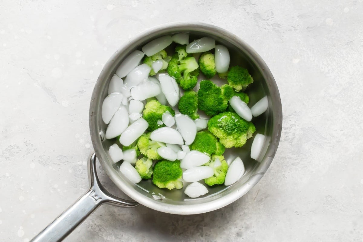 A Chef carefully monitors vegetables being blanched.
