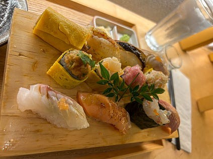 Varied sushi platters with fresh seafood and colorful toppings