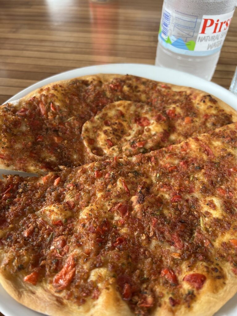 Lahmacun, a thin Turkish flatbread topped with minced meat, vegetables, and herbs
