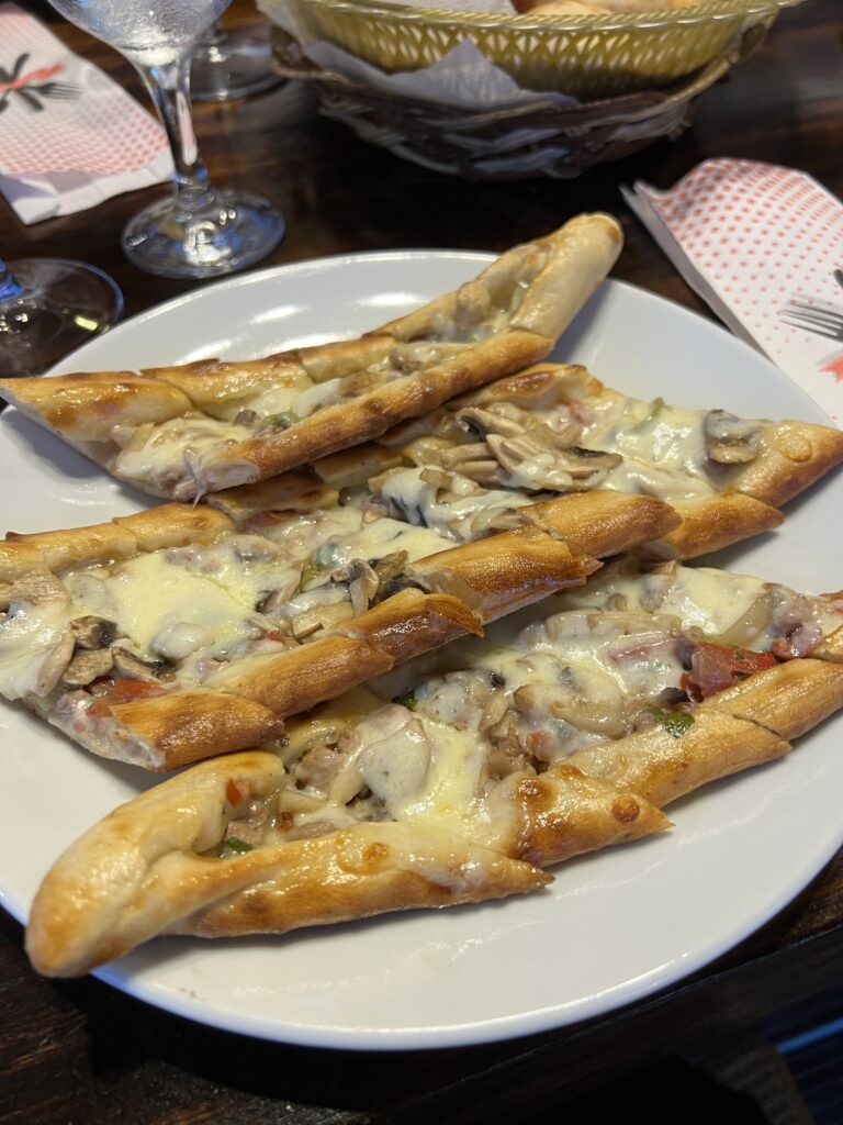 Pide, Turkish flatbread topped with various vegetables and meat