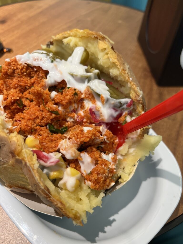 A fully loaded Kumpir, a giant baked potato topped with various fillings at a street stall in Istanbul