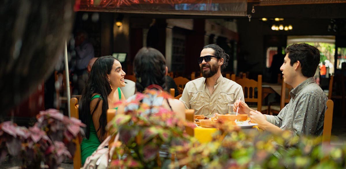 A colorful display of Latin American food, including tacos, burritos, and other dishes.