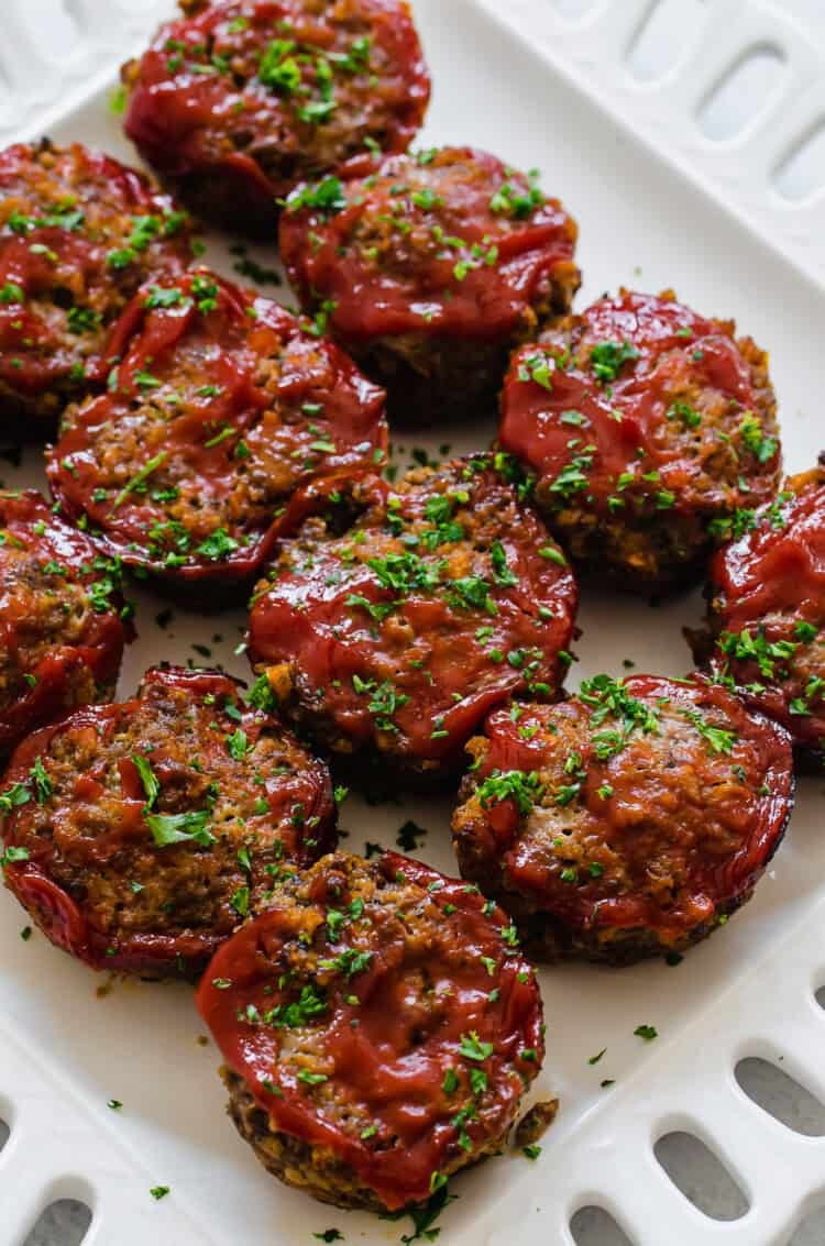 Mini meatloaf muffins lined up on a platter ready to serve.