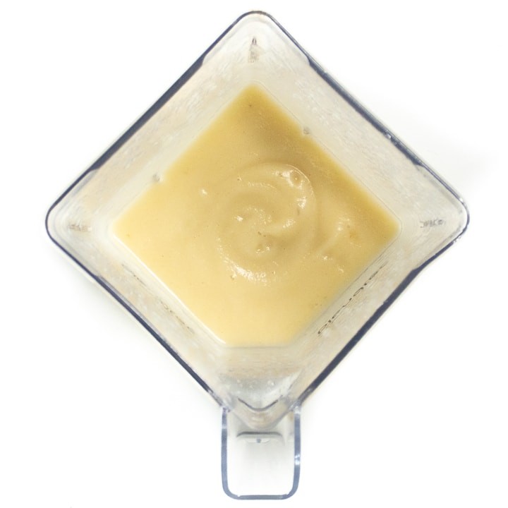 Blender full of homemade baby food pureed to a smooth texture.