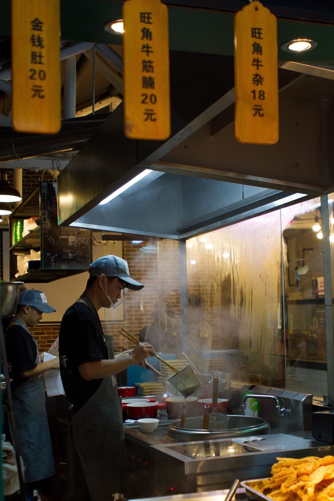 A person holding a plate of steaming hot dim sum from Good Mong Kok Bakery, showcasing the variety and deliciousness of this popular Chinese brunch.