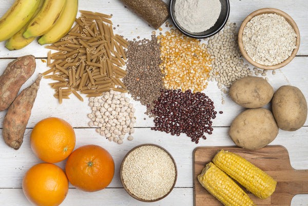 Carbohydrates, including bananas, rice, sweet potatoes, oranges, pasta, corn on the cob, potatoes and more