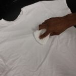 Blotting food coloring stain with a clean cloth