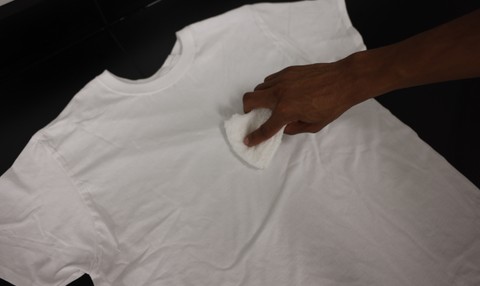 Blotting food coloring stain with a clean cloth