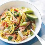Close-up of salmon with peanut and sesame noodles, showcasing a healthy and flavorful meal