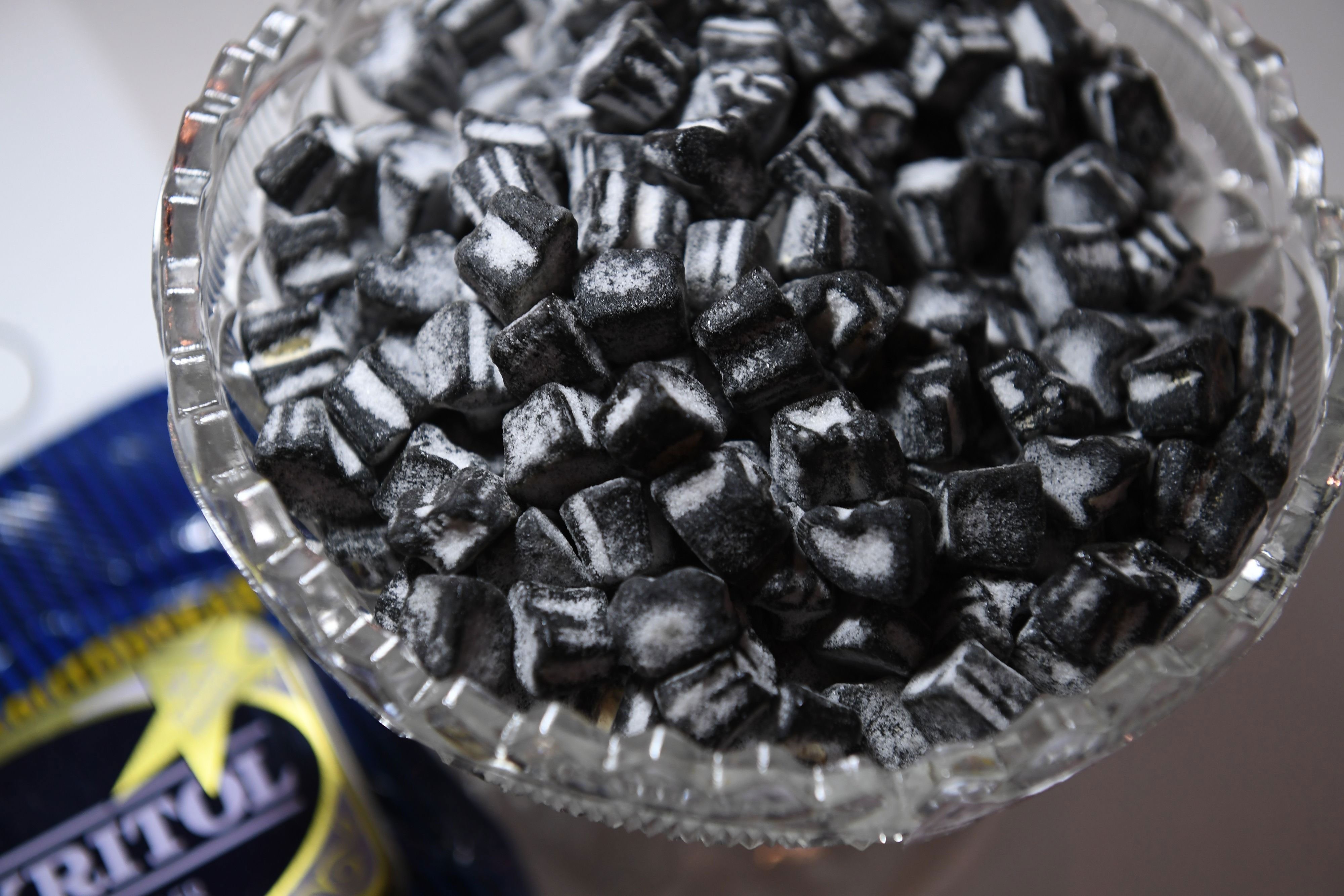 Glass bowl of liquorice sweets. A bowl filled with liquorice sweets.