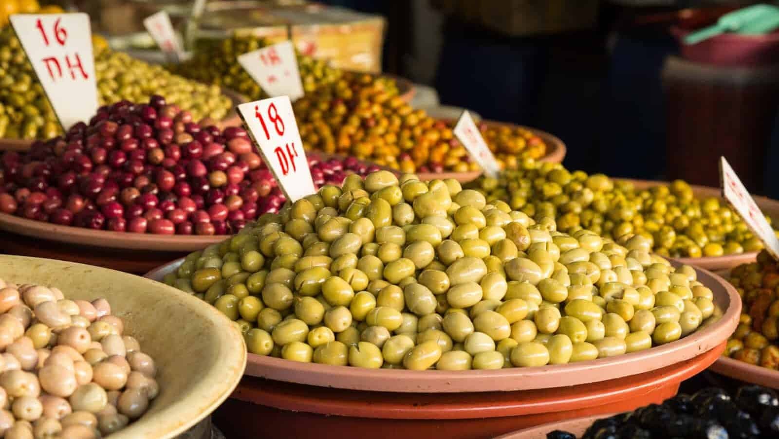 Olives at a market in Morocco, showcasing the fresh and flavorful ingredients that are central to Moroccan cuisine