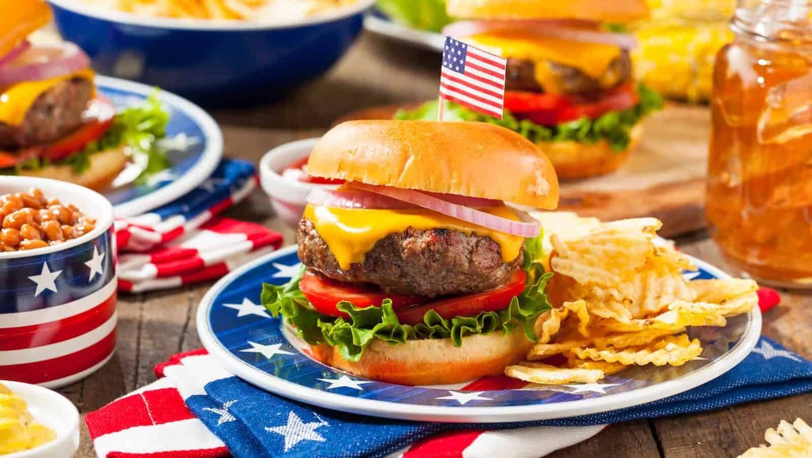 A homemade Memorial Day hamburger picnic with chips and fruit, showcasing the casual and comforting nature of American cuisine