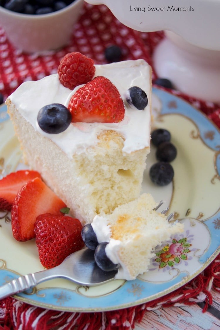 A slice of sugar-free angel food cake with fresh strawberries and a dollop of Greek yogurt