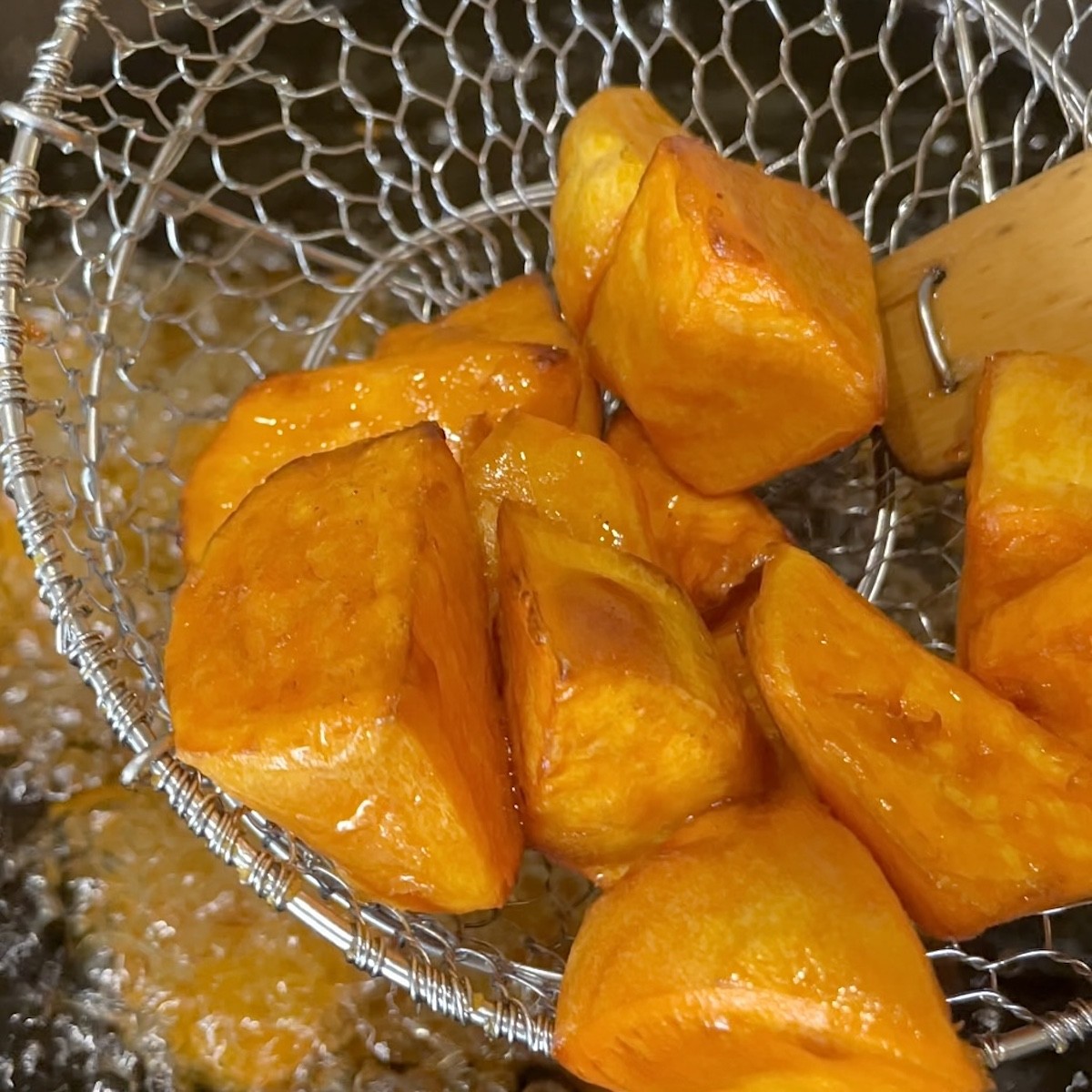 Sweet potatoes frying in a wok
